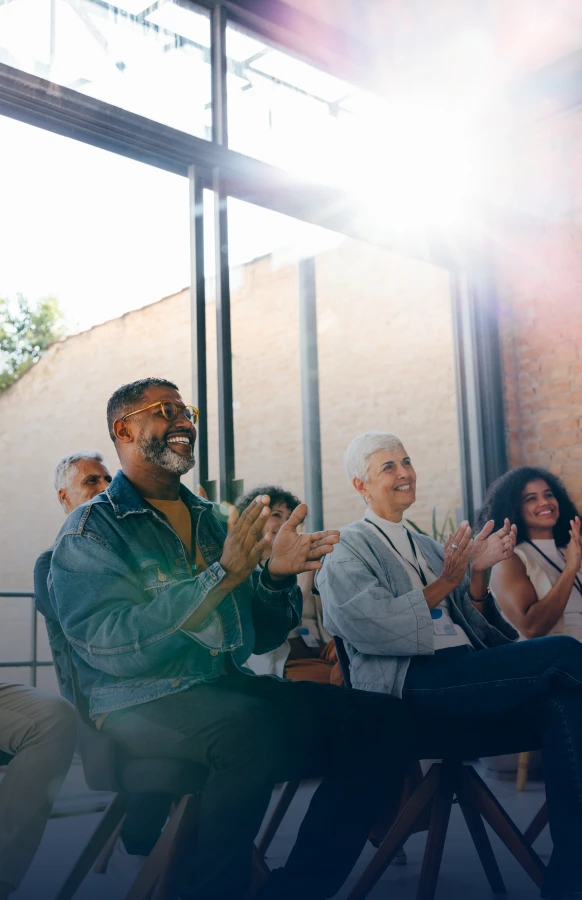Group of people applauding indoors
