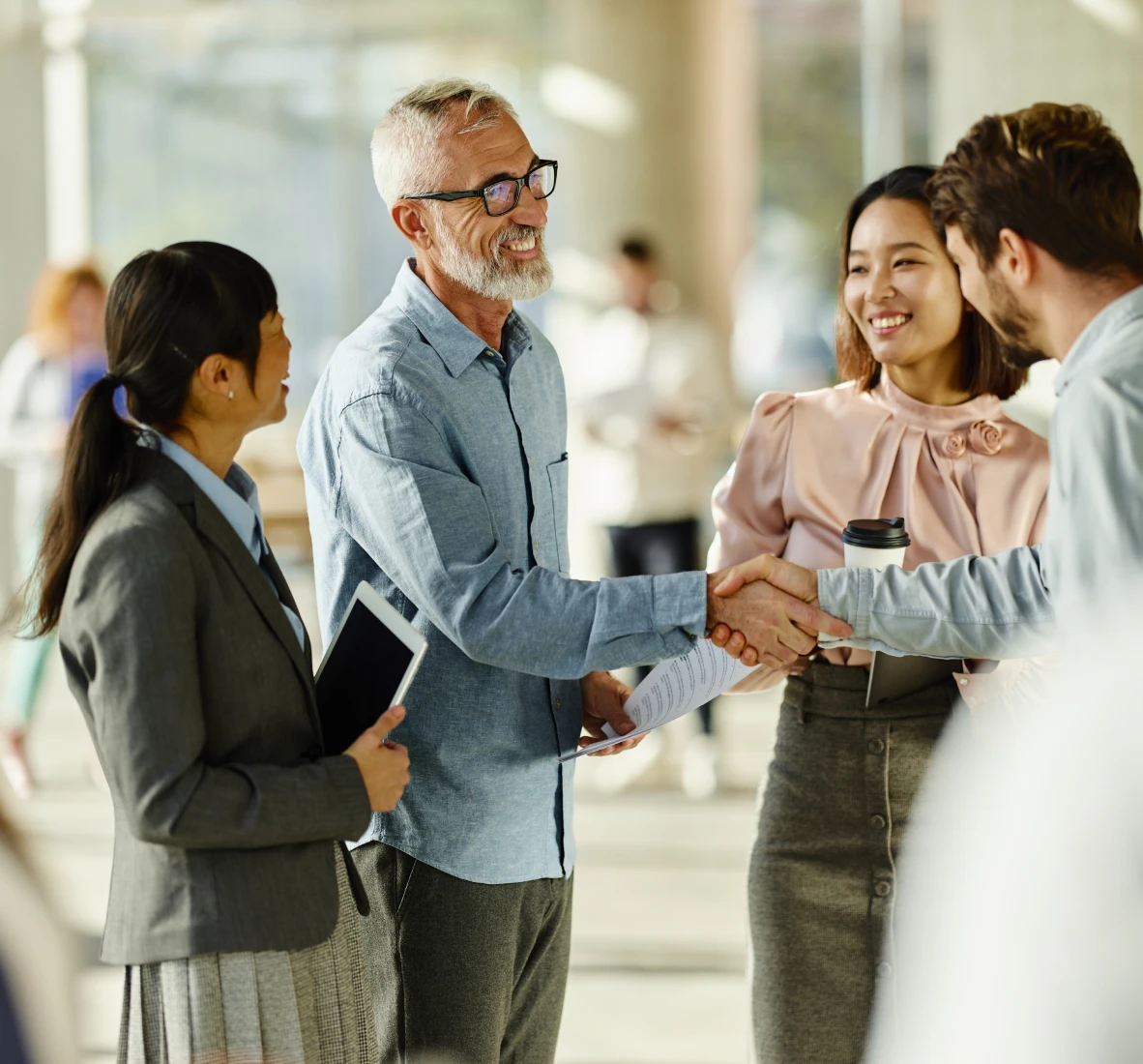 People shaking hands in office setting